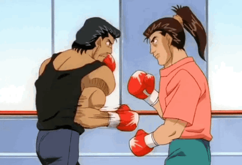 A Man And A Woman Are Boxing In A Ring . GIF