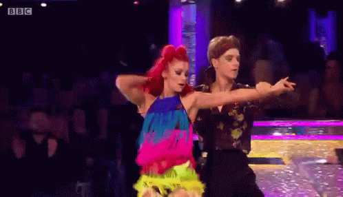 a man and a woman are dancing a dance on a stage .