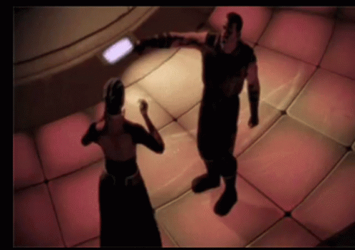 A Man And A Woman Are Dancing In A Room GIF