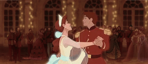 A Man And A Woman Are Dancing In Front Of A Crowd . GIF