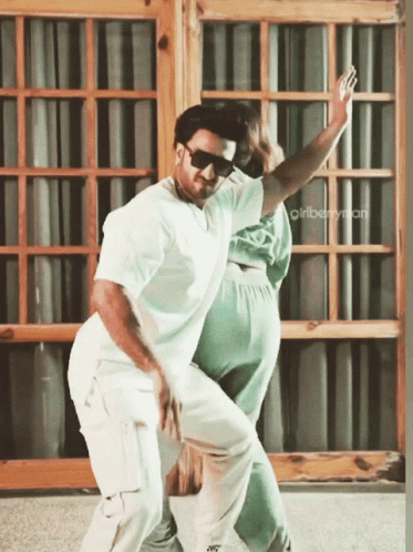 A Man And A Woman Are Dancing In Front Of A Window With The Words Girlberryman On The Bottom GIF