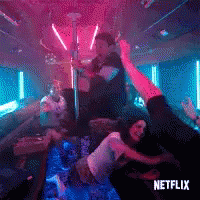 A Man And A Woman Are Dancing On A Pole In A Nightclub . GIF