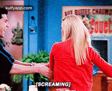 A Man And A Woman Are Dancing Together And The Woman Is Screaming While Holding The Man 'S Arm . GIF