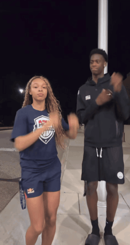 A Man And A Woman Are Dancing Together And The Woman Is Wearing A Shirt That Says ' Ucsd ' On It GIF