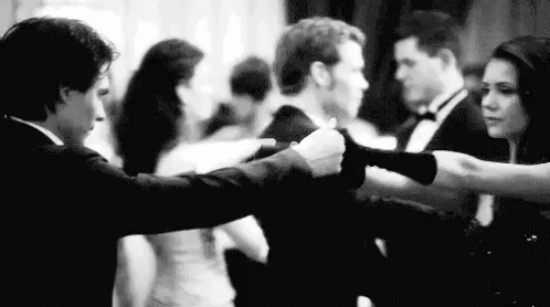 A Man And A Woman Are Dancing Together At A Party . GIF