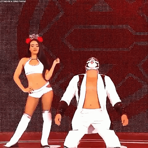 A Man And A Woman Are Dancing Together On A Stage . GIF