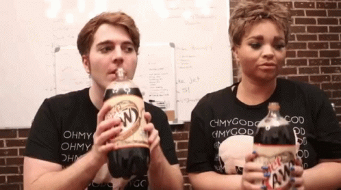 A Man And A Woman Are Drinking A Bottle Of Diet Root Beer GIF