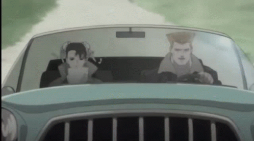 A Man And A Woman Are Driving A Car On A Road GIF
