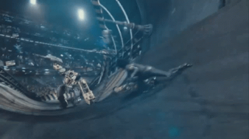 A Man And A Woman Are Fighting Each Other In A Room . GIF