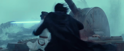 A Man And A Woman Are Fighting Each Other In Front Of A Large Clock . GIF
