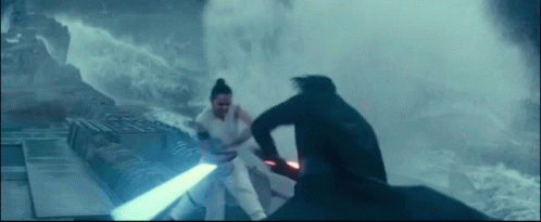 A Man And A Woman Are Fighting Each Other With Lightsabers . GIF