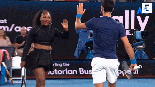 A Man And A Woman Are Giving Each Other High Fives On A Tennis Court GIF