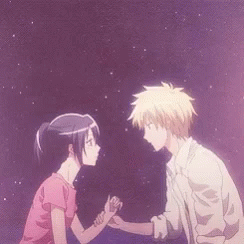 A Man And A Woman Are Holding Hands And Looking At Each Other GIF