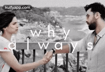 A Man And A Woman Are Holding Hands And Looking At Each Other While Standing Next To Each Other . GIF