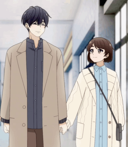 A Man And A Woman Are Holding Hands And Smiling GIF