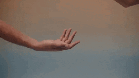 A Man And A Woman Are Holding Hands In A Close Up Of Their Hands . GIF
