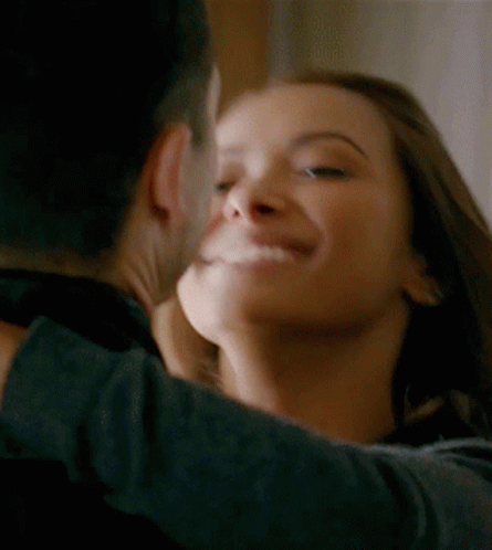 A Man And A Woman Are Hugging And Kissing GIF
