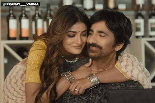 A Man And A Woman Are Hugging And Looking At A Laptop With A Watermark That Says Pranay Varma GIF