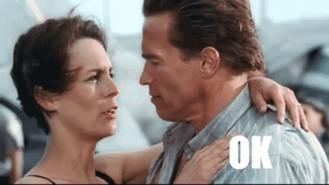 A Man And A Woman Are Hugging And The Word Ok Is On The Shoulder Of The Man GIF