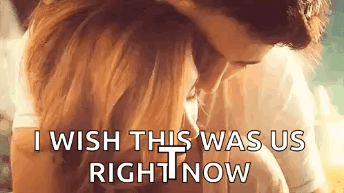 A Man And A Woman Are Hugging Each Other And Kissing . GIF