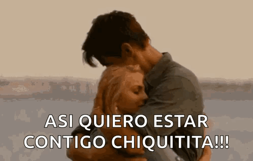 A Man And A Woman Are Hugging Each Other And The Man Is Saying `` Asi Quiero Estar Contigo Chiquita '' . GIF