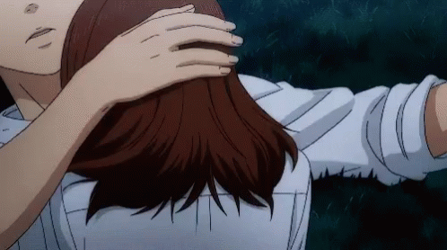 A Man And A Woman Are Hugging Each Other And The Woman Is Touching The Man 'S Hair . GIF
