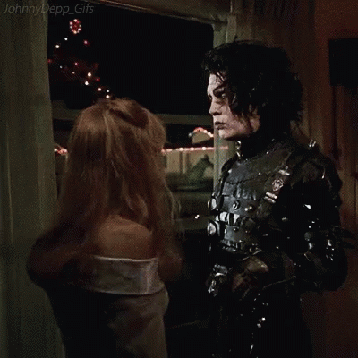 A Man And A Woman Are Hugging Each Other In A Room In A Movie . GIF