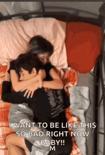 A Man And A Woman Are Hugging Each Other On A Bed With The Words " I Want To Be Like This So Bad Right Now Baby " GIF