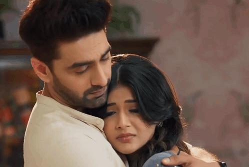 A Man And A Woman Are Hugging Each Other GIF