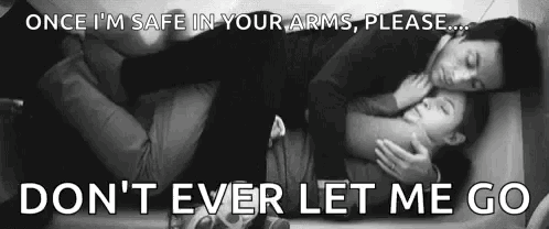 A Man And A Woman Are Hugging Each Other While Laying On A Bed . GIF