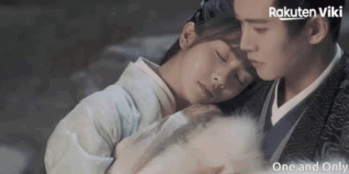 A Man And A Woman Are Hugging Each Other With Rakuten Viki Written On The Bottom Right GIF