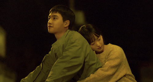 a man and a woman are hugging each other with the woman 's head on the man 's shoulder