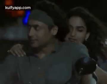 A Man And A Woman Are Hugging In A Dark Room With The Words Kulfyapp.com Visible In The Corner GIF