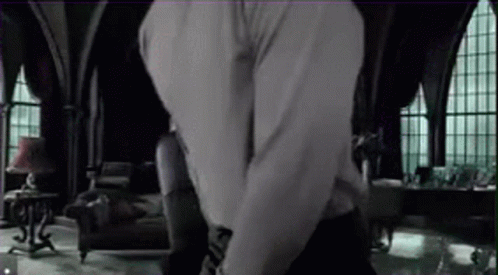 A Man And A Woman Are Hugging In A Living Room With A Lot Of Windows . GIF