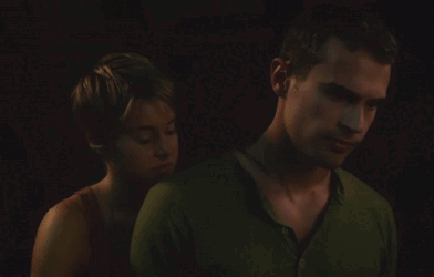 A Man And A Woman Are Hugging In The Dark GIF