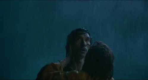 A Man And A Woman Are Hugging In The Water And The Woman Is Holding The Man 'S Neck . GIF