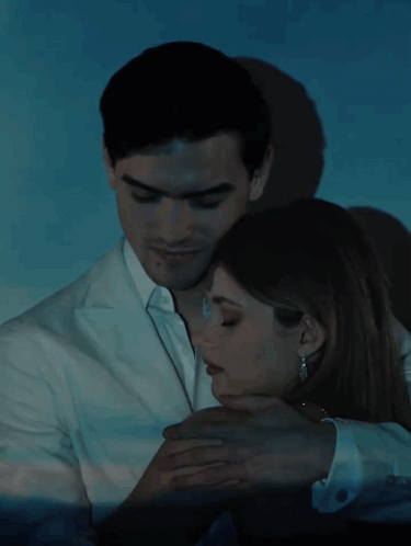 A Man And A Woman Are Hugging With The Words Culpa Nuestra Written Below Them GIF