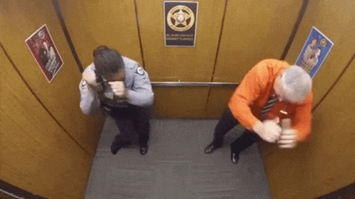 A Man And A Woman Are In An Elevator With A Sign That Says El Paso County Sheriff 'S Office GIF