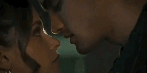 A Man And A Woman Are Kissing Each Other . GIF