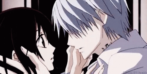A Man And A Woman Are Kissing Each Other In A Dark Room . GIF