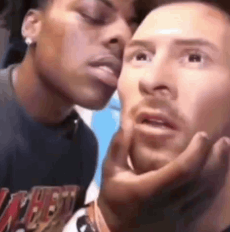 A Man And A Woman Are Kissing Each Other On The Cheeks . GIF