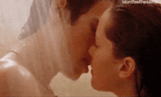 A Man And A Woman Are Kissing In A Bathroom . GIF