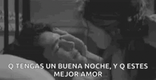 A Man And A Woman Are Kissing In A Bed . GIF