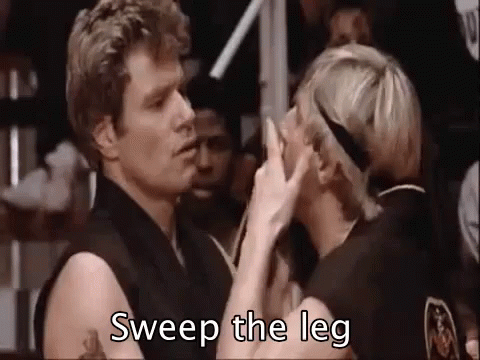 A Man And A Woman Are Kissing In A Boxing Ring And The Man Is Saying `` Sweep The Leg '' . GIF