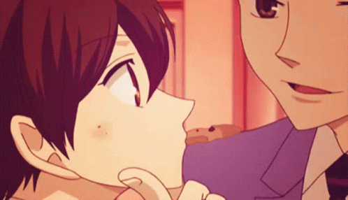 A Man And A Woman Are Kissing In A Cartoon GIF