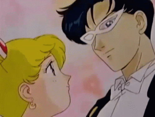 A Man And A Woman Are Kissing In A Cartoon Scene GIF