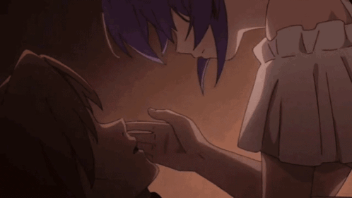 A Man And A Woman Are Kissing In A Dark Room GIF