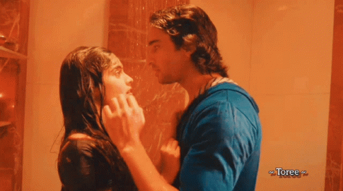 A Man And A Woman Are Kissing In A Shower With Toree Written On The Bottom Right GIF