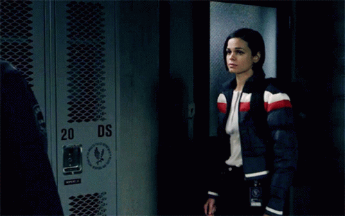 A Man And A Woman Are Kissing In Front Of Lockers With The Number 34 On Them GIF