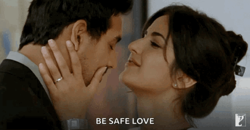 A Man And A Woman Are Kissing With The Words Be Safe Love Behind Them GIF